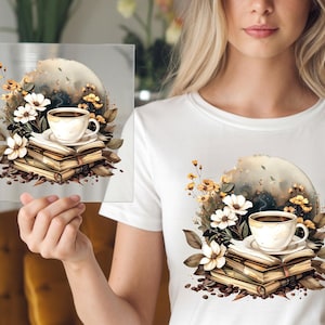 May include: A white t-shirt featuring a watercolor design of a coffee cup on a stack of books, surrounded by flowers and coffee beans. The design includes a soft, neutral color palette with a dreamy aesthetic.
