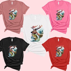 May include: A selection of short-sleeved t-shirts in shades of pink, red, black, white, and mauve. Each tee displays a watercolour-style image of a deer with large antlers, leaping over fish in a watery setting.