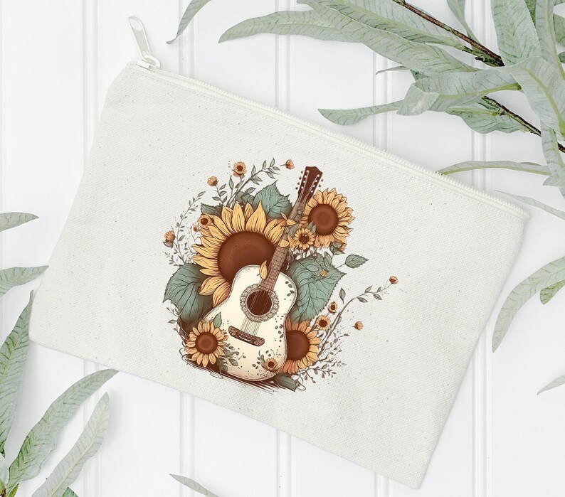 May include: A white canvas makeup bag with a floral design featuring a white acoustic guitar with sunflowers and green leaves.