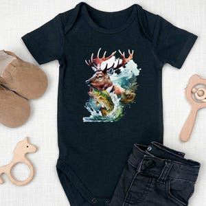 May include: Black baby bodysuit featuring a deer, fish, and water scene graphic. The short-sleeved bodysuit has a snap closure. The image is surrounded by baby shoes, a wooden rattle, and a wooden horse toy.