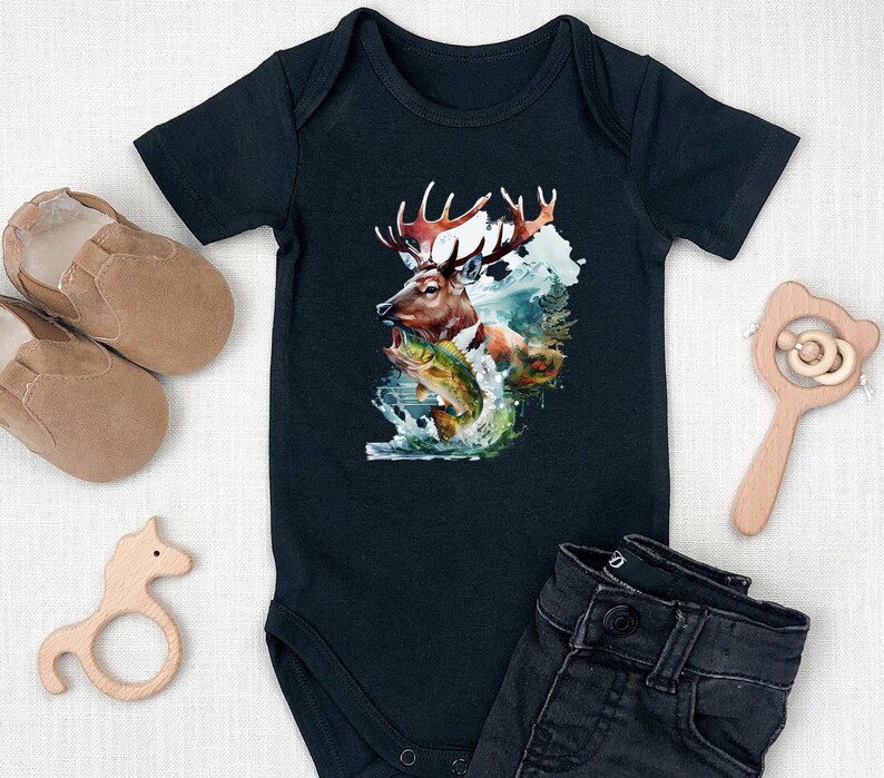 May include: Black baby bodysuit featuring a deer, fish, and water scene graphic. The short-sleeved bodysuit has a snap closure. The image is surrounded by baby shoes, a wooden rattle, and a wooden horse toy.
