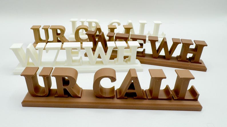 Custom 3D-printed ham radio callsign desk plaques in several colors