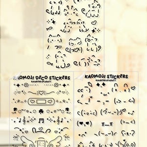 May include: Transparent sticker sheets with black kaomoji and decorative designs. The sheets include "Kitty Kaomoji Stickers" with emoticons, and "Kaomoji Deco Stickers" with hearts, stars, musical notes, and other designs.