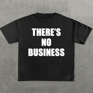 May include: Black t-shirt with white text that reads "THERE'S NO BUSINESS"