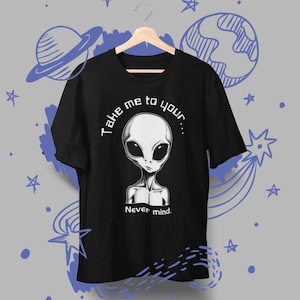 May include: Black t-shirt featuring a gray alien graphic with the text "Take me to your... Never mind." The alien has large black eyes and a slender neck. The shirt is hanging on a wooden hanger.
