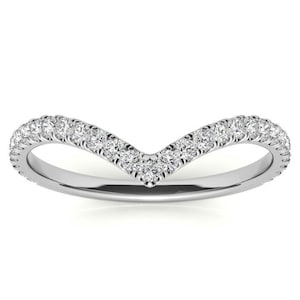 May include: A delicate, V-shaped wedding band with a row of sparkling diamonds set in a polished silver band.