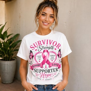 May include: White t-shirt with a pink ribbon design, butterflies, and the words "Survivor Strength, Support, Love, Supporter, Hope." The shirt also includes the phrases "I fought, I won, I am" and "Stronger than cancer."