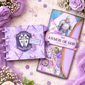 May include: A purple journal and a decorative book with the text "The Armor of God" and "Ephesians 6:10-18". The journal has a shield design with the words "Put on the Full Armor of God". The book features a knight illustration.