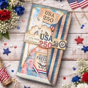 May include: A patriotic scrapbook-style card with a USA 250 theme. The card features red, white, and blue colors, with decorative elements like stars, flags, and floral accents. The card is designed with a vintage aesthetic.