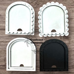 May include: Four wooden arch-shaped trays in white and black, with scalloped edges. The trays have a cutout at the bottom. The text "Brookwood Mercantile" is visible on the image.