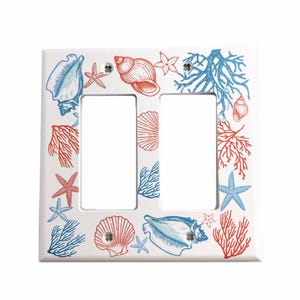 May include: White double light switch cover with a seashell and coral design. The design features blue and red seashells, coral, and starfish.
