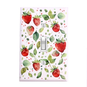 May include: White light switch cover with a watercolor pattern of red strawberries and green leaves.