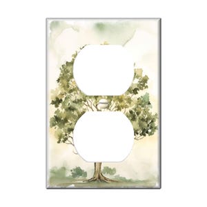 May include: A watercolor painting of a tree with green leaves and a brown trunk. The painting is on a white background and is framed by a white border. The painting is designed to fit over a standard electrical outlet.