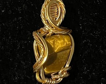 Small gold color wire wrapped tigers eye pendant