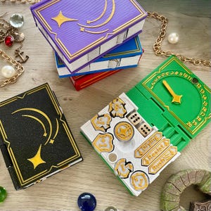 Caja de fichas con forma de libro, fichas y contador de tradición inspirados en el juego de cartas Lorcana