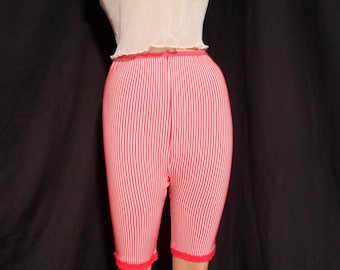 May include: Red and white striped knit shorts with a ruffled hem. The shorts are made of a soft, stretchy material and are perfect for lounging or working out.