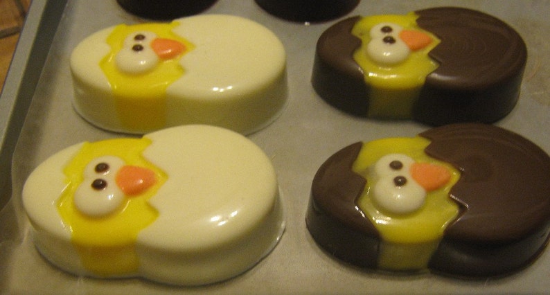 One dozen chick popping out of an egg chocolate covered sandwich cookie image 1