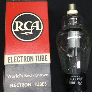May include: An RCA Radiotron electron tube and its original box. The box is red and black with the RCA logo and the words "Electron Tube" and "World's Best-Known Electron Tubes." The tube is made of clear glass.