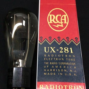 May include: A clear glass vacuum tube with a black base labeled Radiotron UX-281, positioned next to a rectangular red, white, and blue box. The box features the RCA logo, the text UX-281, Radiotron Electron Tube, and Made in U.S.A.