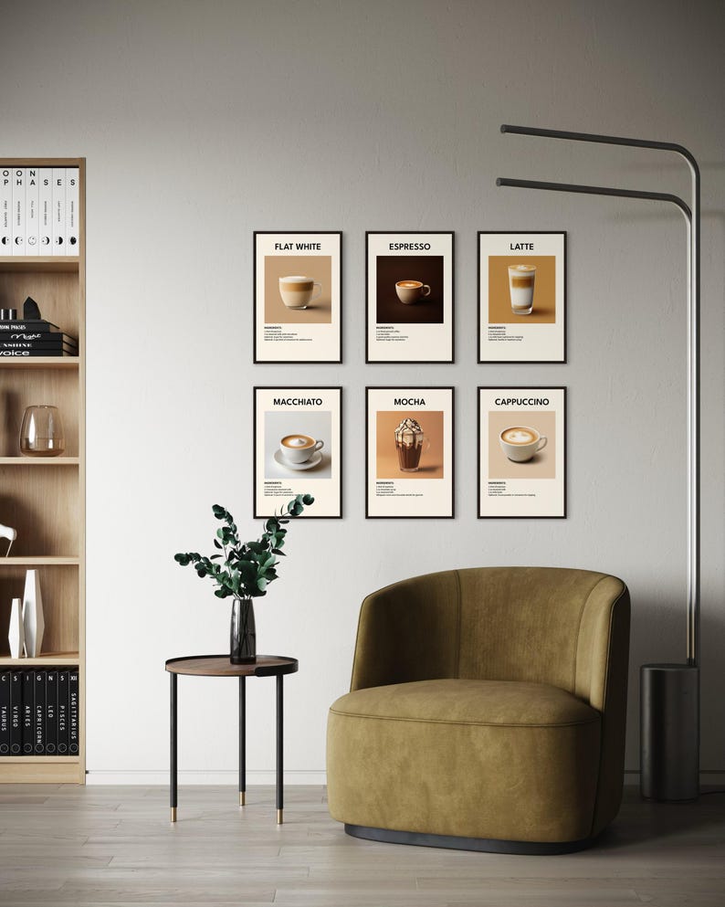 May include: Six black framed prints with white backgrounds and black text. Each print features a different type of coffee drink, including flat white, espresso, latte, macchiato, mocha, and cappuccino. The prints are displayed on a white wall above a brown armchair and a small round table with a green plant.