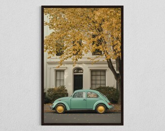 May include: A vintage light blue Volkswagen Beetle parked in front of a white house with a yellow tree in the background.