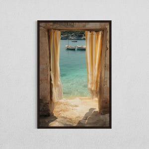 May include: A framed photograph shows a coastal vista. A stone doorway frames a view of turquoise water, a sandy beach, and two boats. Yellow and white striped curtains hang on either side of the opening, adding colour to the tranquil scene.