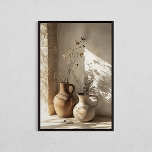 May include: A framed print featuring two ceramic vases with dried floral arrangements. The vases are in shades of brown and beige, with one having a handle. The background includes a stone wall and shadows.