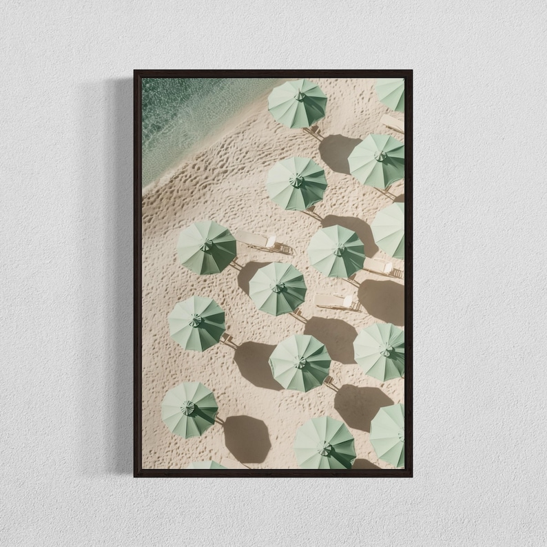 May include: An aerial view of a sandy beach with rows of green umbrellas and white lounge chairs.
