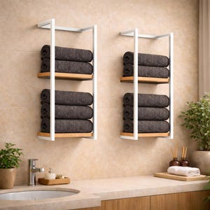 Modern towel shelf mounted on wall with stacked towels