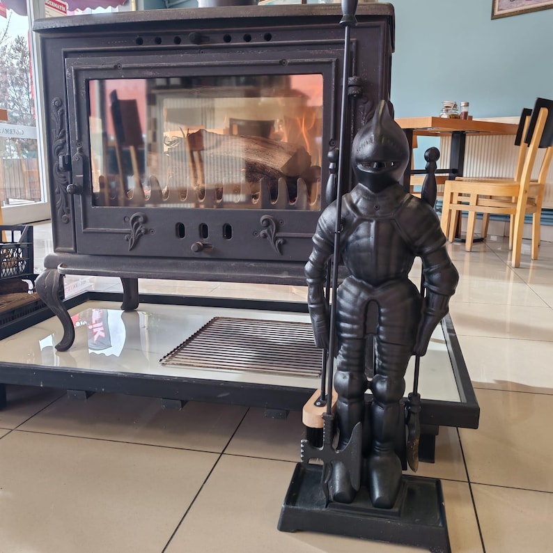Rustic fireplace tool set featuring a knight-shaped holder and essential tools for maintaining a clean and stylish hearth.