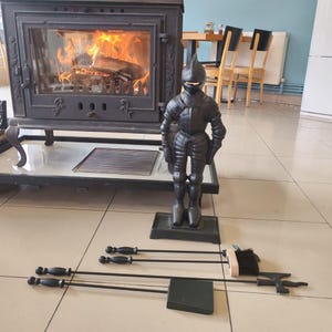 Rustic fireplace tool set featuring a knight-shaped holder and essential tools for maintaining a clean and stylish hearth.