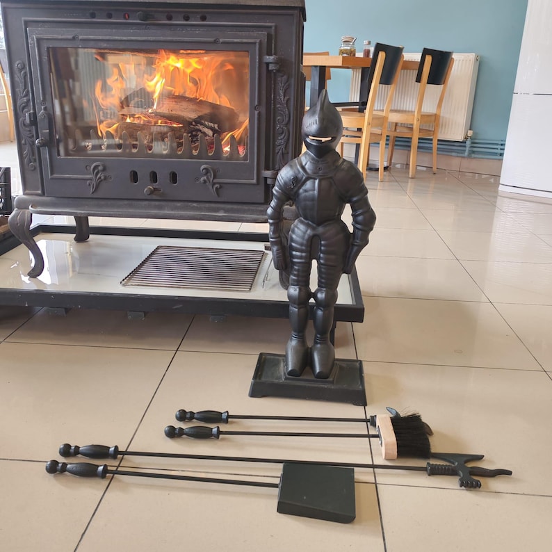 Rustic fireplace tool set featuring a knight-shaped holder and essential tools for maintaining a clean and stylish hearth.