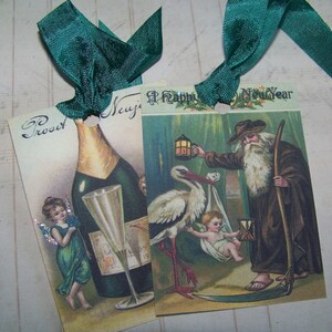 May include: Two vintage Christmas gift tags with green ribbon. The first tag features a bottle of champagne with a glass and a fairy with green wings. The second tag features a stork carrying a baby, a man with a lantern and the text "A Happy New Year".