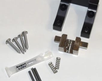 Puede incluir: Un kit de herrajes que contiene un soporte negro en forma de U, un bloque metálico plateado con un logotipo E, cuatro tornillos, dos resortes helicoidales pequeños, tres pasadores metálicos largos, un pasador corto y un tubo de grasa Super Lube.