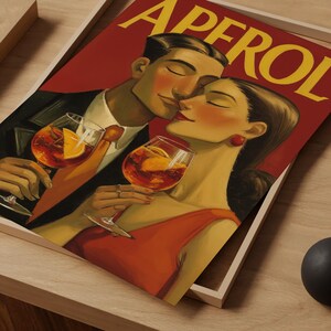 May include: A vintage-style print featuring a couple enjoying cocktails. The artwork depicts a man and woman in a romantic embrace, holding glasses of an orange-colored drink with orange slices. The word "APEROL" is displayed in large yellow letters at the top.