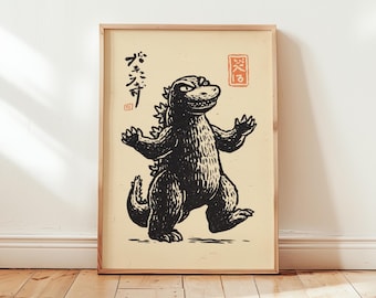 May include: A framed print featuring a black and white illustration of Godzilla with arms outstretched. Japanese text is above the image, and a red stamp is on the right. The background is a light beige color.
