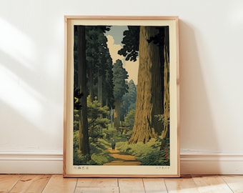 May include: Framed art print depicting a forest scene with tall trees and a path. The artwork uses greens, browns, and blues, with a person walking on the path. The print is in a light wood frame and rests against a white wall.