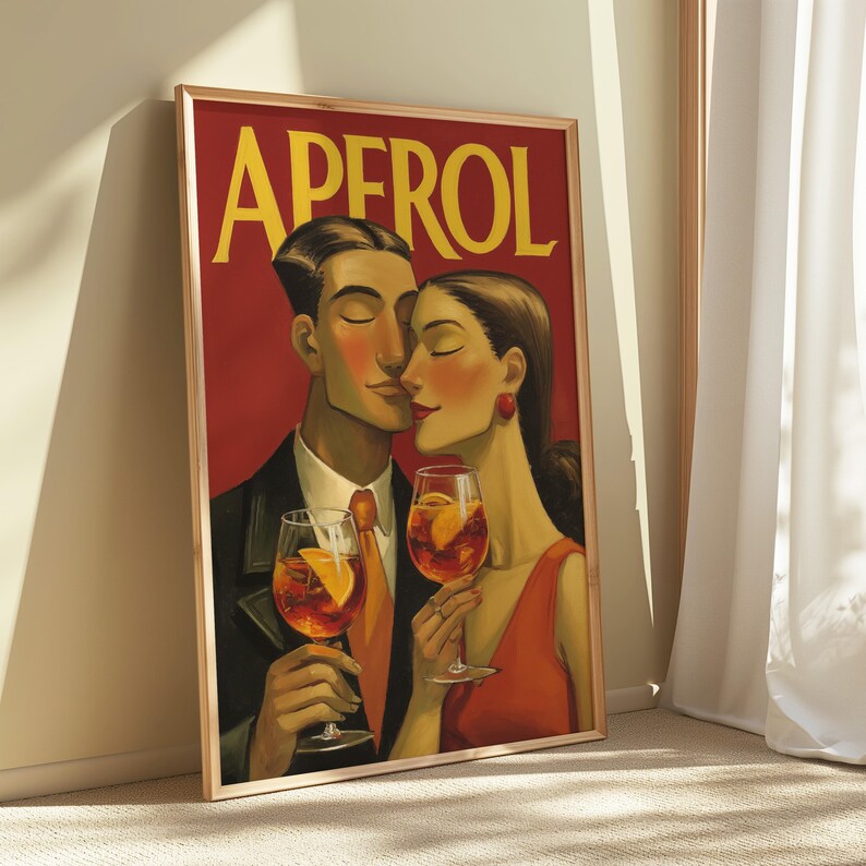 May include: A framed art print featuring a couple holding Aperol spritzes. The artwork has a vintage style with a red background and the word "APEROL" in yellow. The couple is depicted in a romantic embrace, with the woman wearing a red dress.