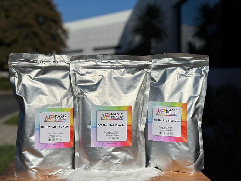 May include: Three silver bags of DTF Hot Melt Powder from Magic Print4U. Each bag has a label with the company logo and product name.