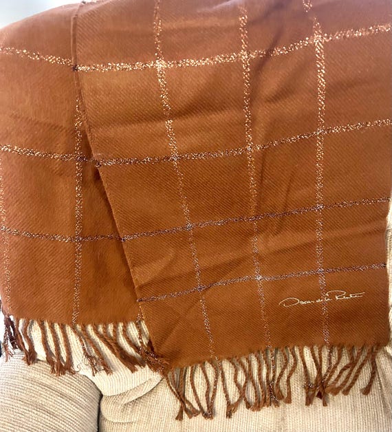 Oscar De La Renta designer 5 foot long scarf/wrap with bronze stitching. Cozy and warm made with 100 percent Acrylic with fringed edges.