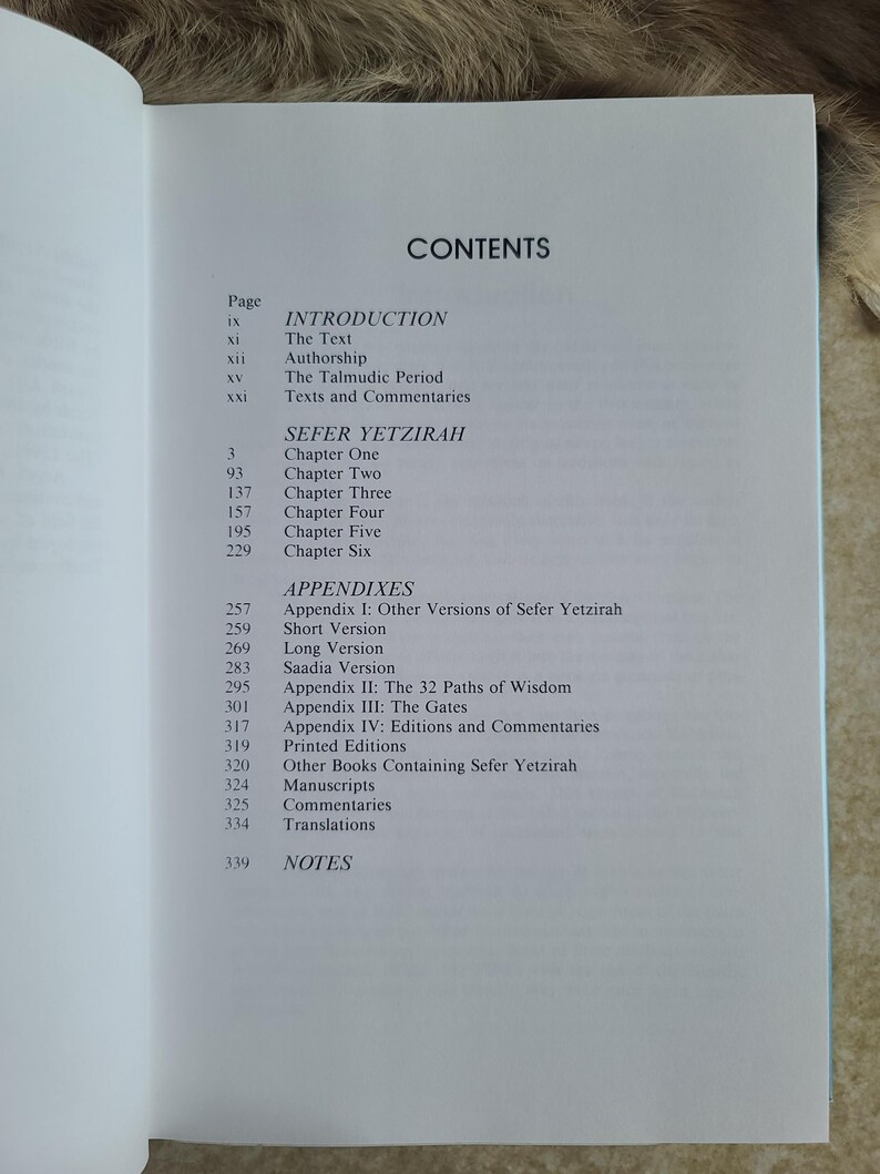 May include: Open book page with the title "CONTENTS" at the top. The page lists the table of contents for "SEFER YETZIRAH", including chapters, appendices, and notes. The text is in black font on a white background.