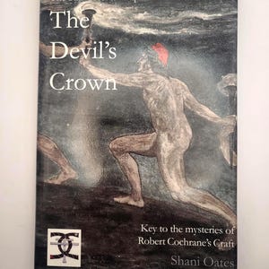 May include: A book cover titled "The Devil's Crown" with an illustration of a nude figure holding a torch. The cover also includes the text "The Star Crossed Serpent IV" and "Key to the mysteries of Robert Cochrane's Craft".