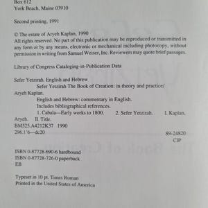 May include: A printed page from a book titled "Sefer Yetzirah The Book of Creation: in theory and practice" by Aryeh Kaplan. The text includes publication information, Library of Congress data, and ISBN numbers. The book was printed in the United States.