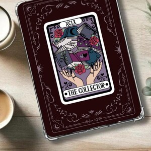 May include: Printable digital download of a tarot card design featuring a dark purple background with a white border. The card depicts a hand holding a stack of books with roses and a crescent moon. The card number is XCIX and the title is "THE COLLECTOR".