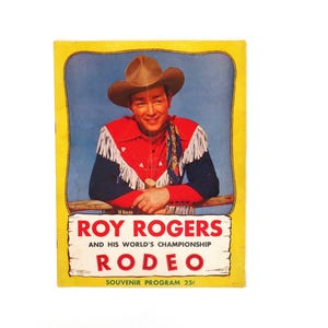 May include: A vintage souvenir program for Roy Rogers and His World's Championship Rodeo. The cover features a color photo of Roy Rogers in a cowboy hat and red shirt, with the text "Roy Rogers and His World's Championship Rodeo" and "Souvenir Program 25c".