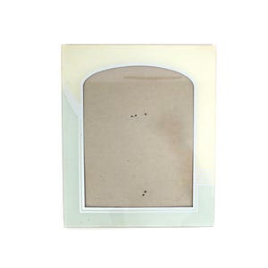 May include: A rectangular photo frame with a cream-colored border and a light green inner frame. The frame has an arched top and a white inner border. The photo area is a light brown color.