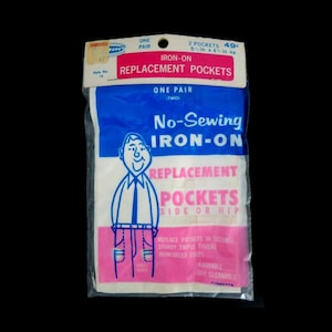 May include: A package of two iron-on replacement pockets. The package is blue and white with a cartoon man wearing a white shirt and a blue tie. The text on the package reads "No-Sewing Iron-On Replacement Pockets Side or Hip".