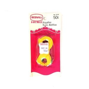 May include: A package of Scovill Hero Argylette Yarn Bobbins, a set of 10 yarn bobbins for making argyle socks, ties, sweaters, and more. The package is pink and white with a picture of the bobbins and the text "No. 7116 50¢".
