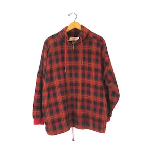 May include: Red, black, and brown plaid fleece pullover with a half-zip closure and a drawstring hood.
