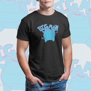 May include: A black t-shirt with a blue and pink cartoon character graphic and the text "BIG MAN" in pink and blue letters.